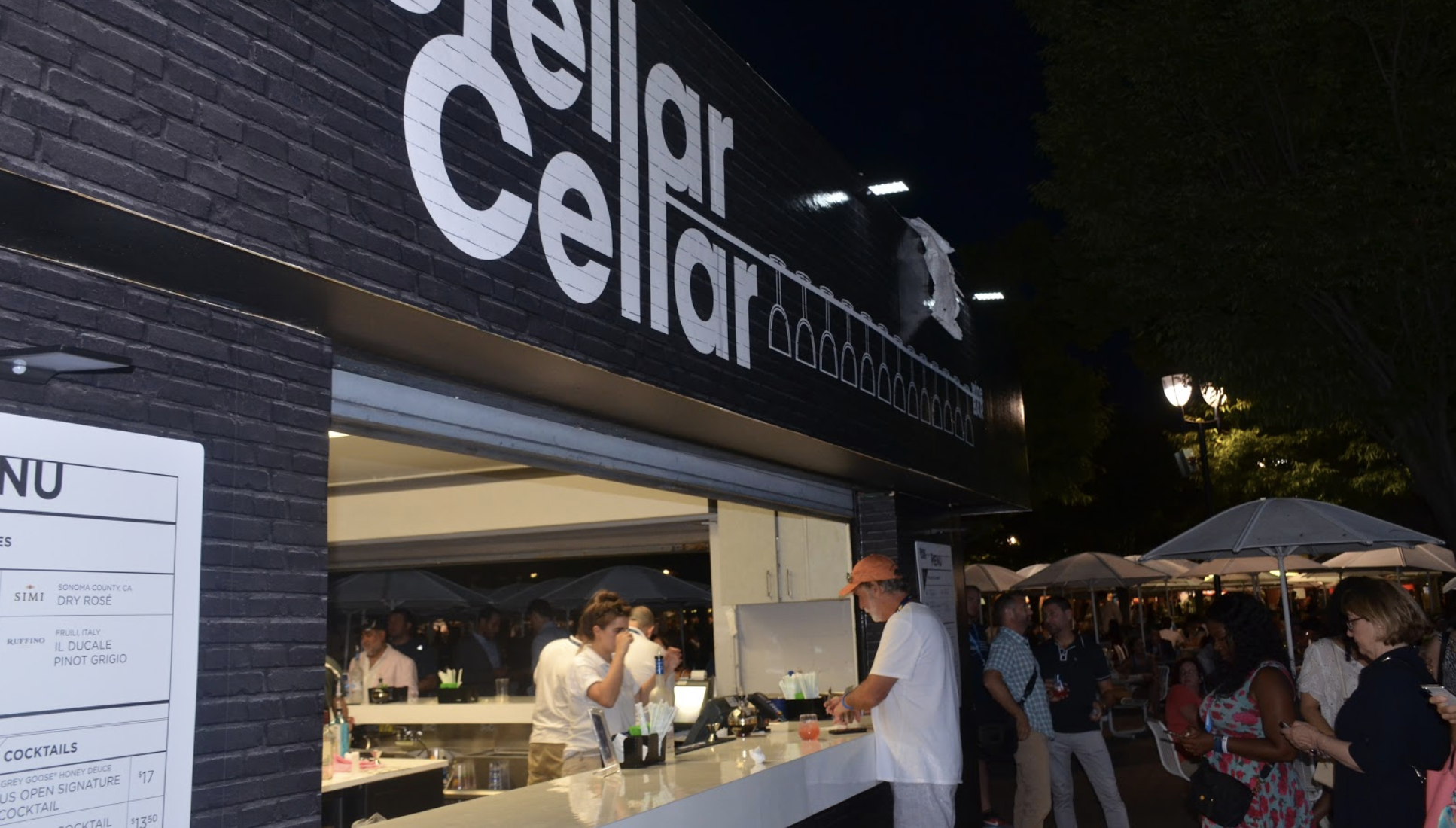 Night Image of Stellar Cellar Pop Up Bar with Consumers