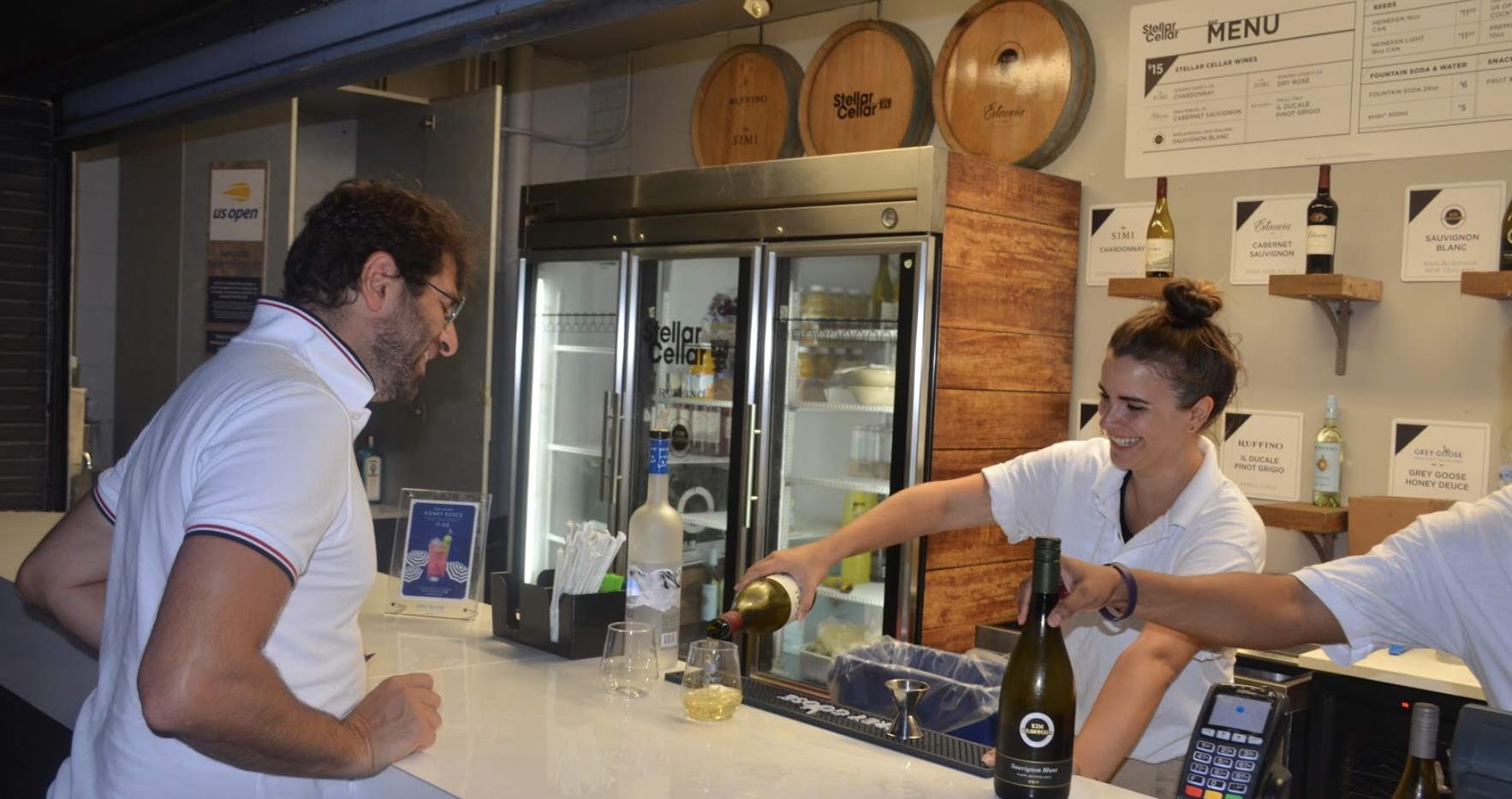 Consumer being served a beverage at the Stellar Cellar